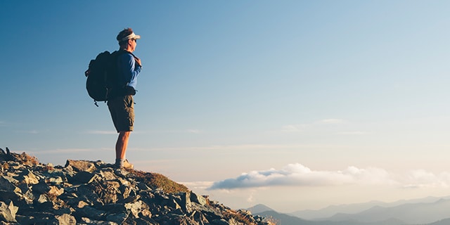 Man Hiking up mountain in the sky